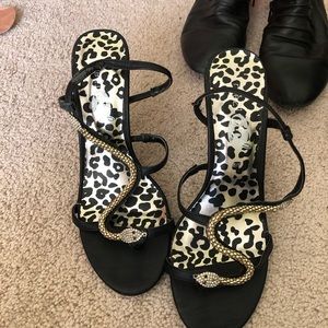 black heels with snakes on straps